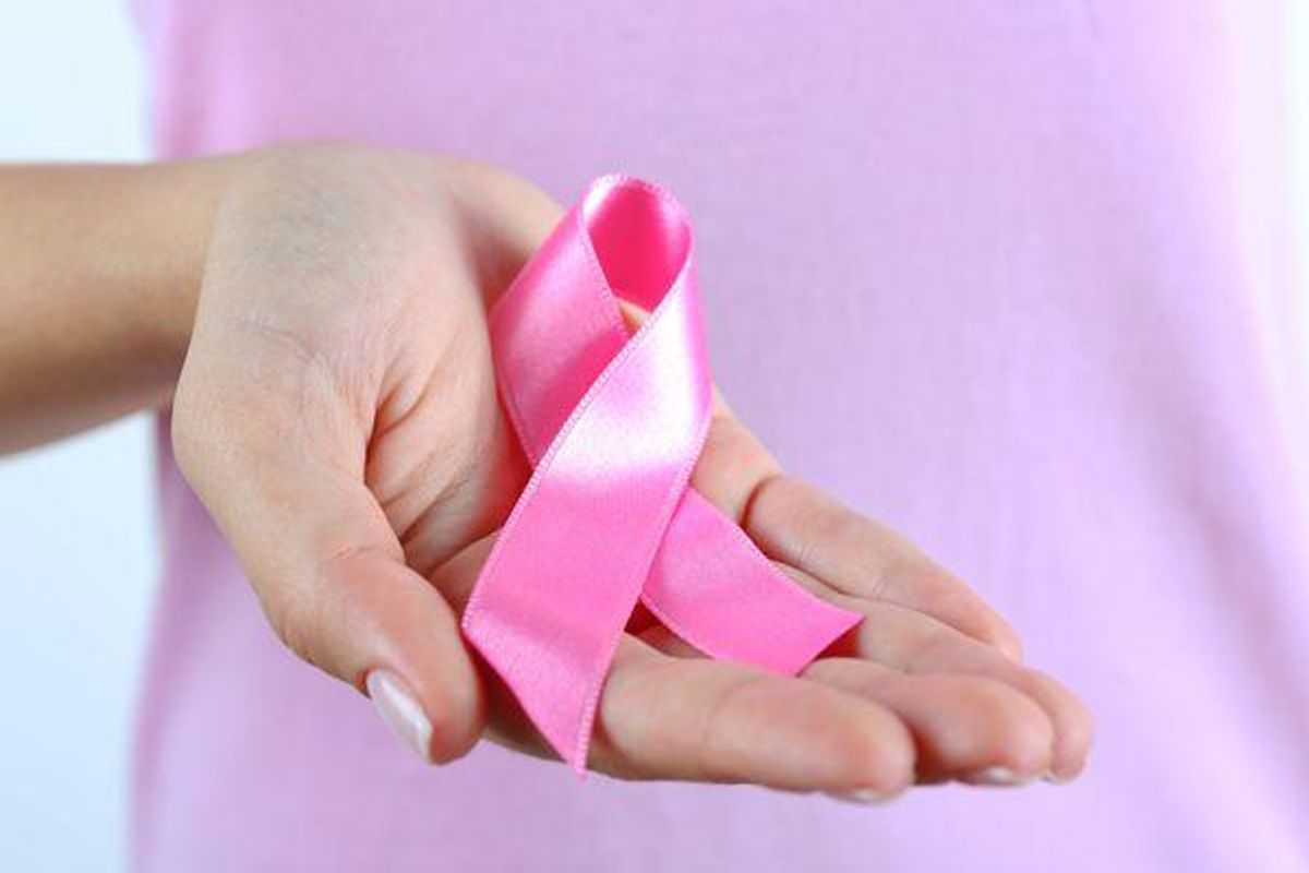 woman holding a pink ribbon