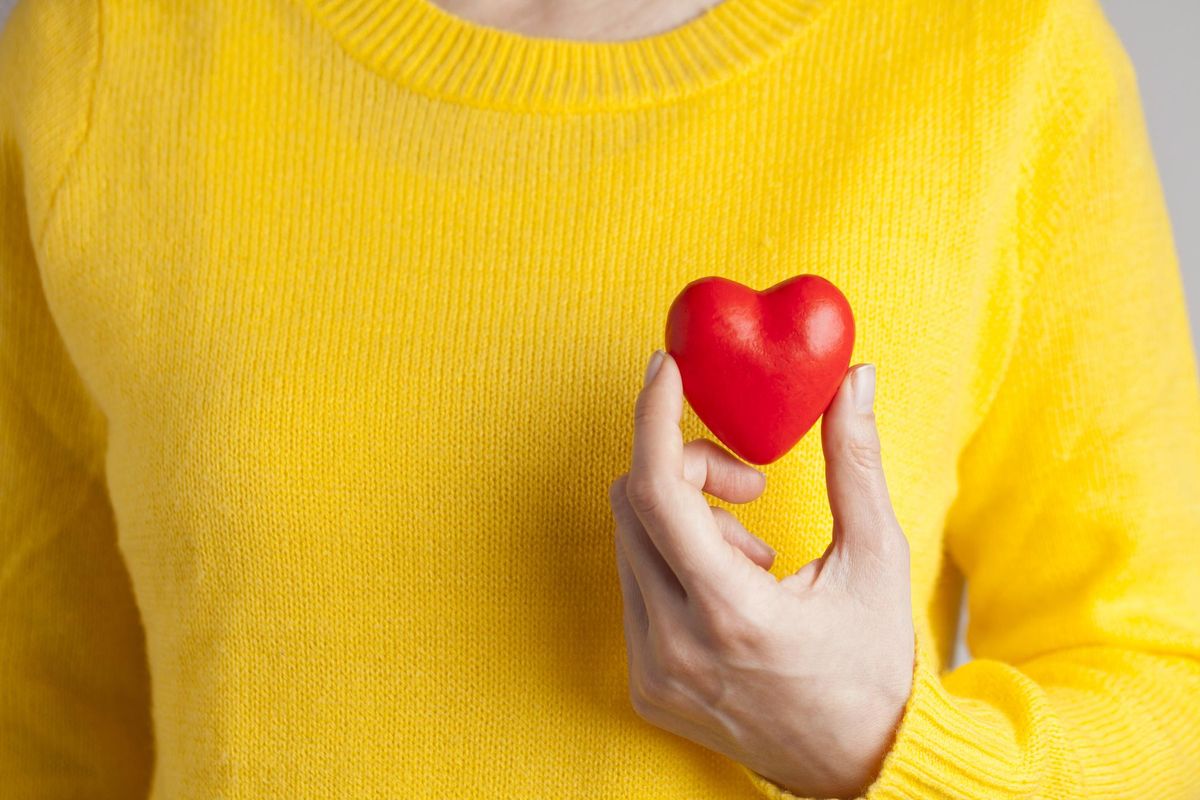 woman holding a plastic shaped heart