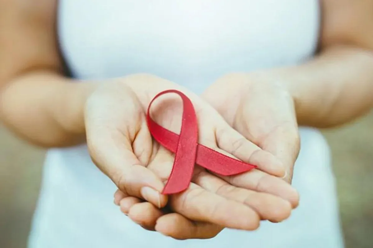woman holding an aids awareness ribbon