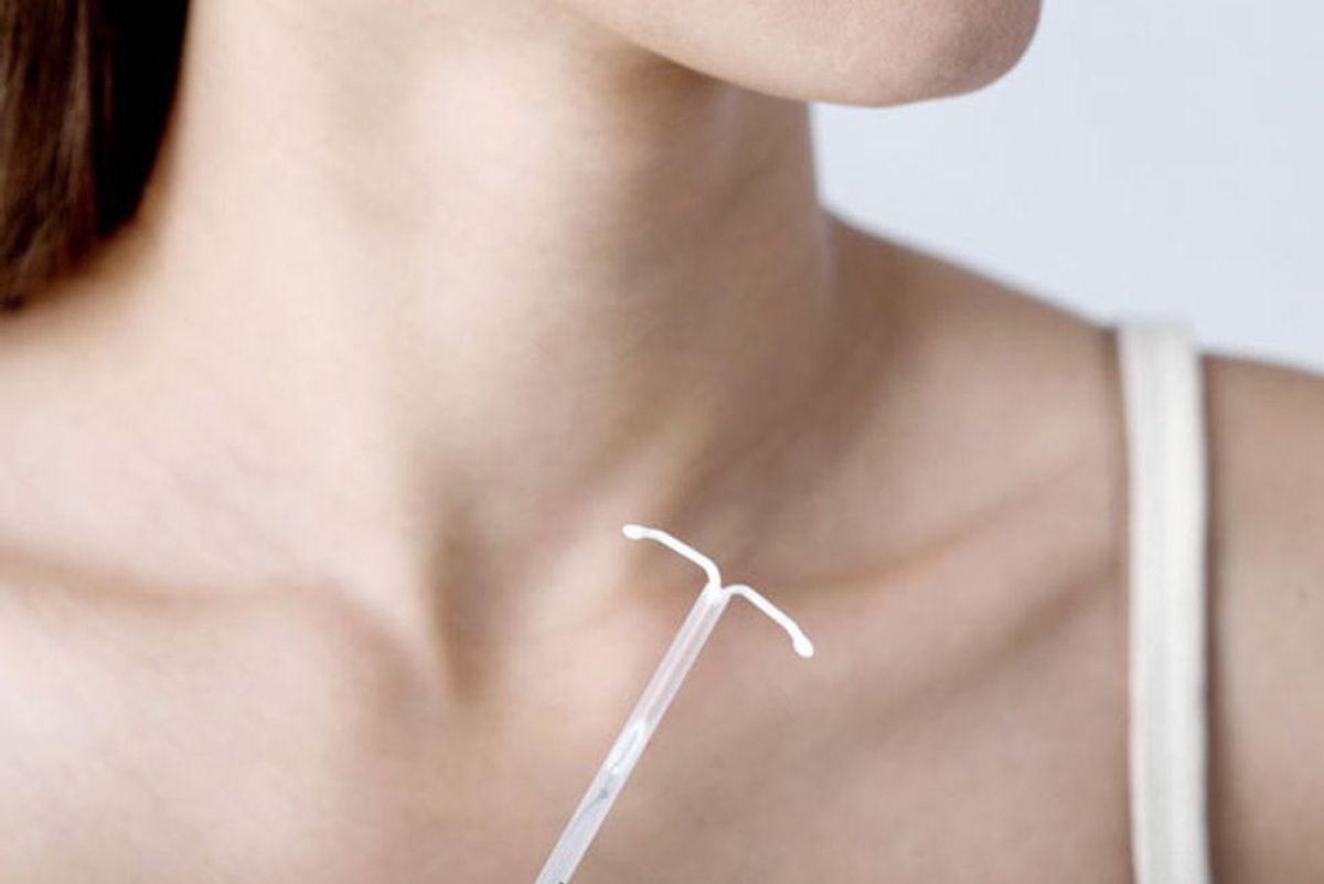 woman holding an IUD