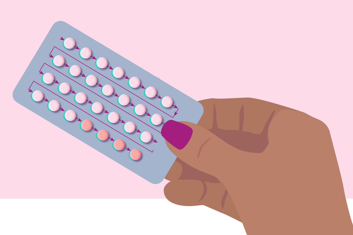 woman holding birth control pills