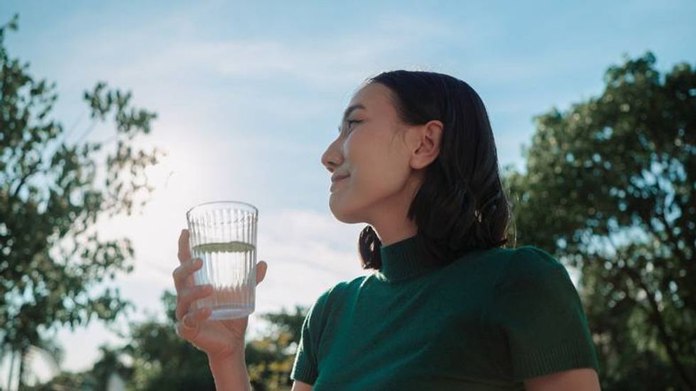 woman holding glass in her yard