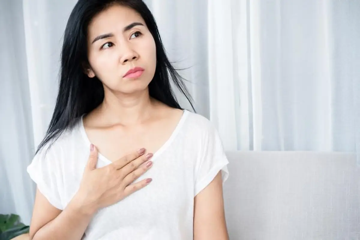woman holding her chest