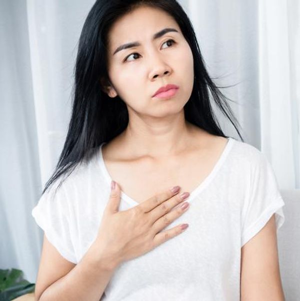 woman holding her chest
