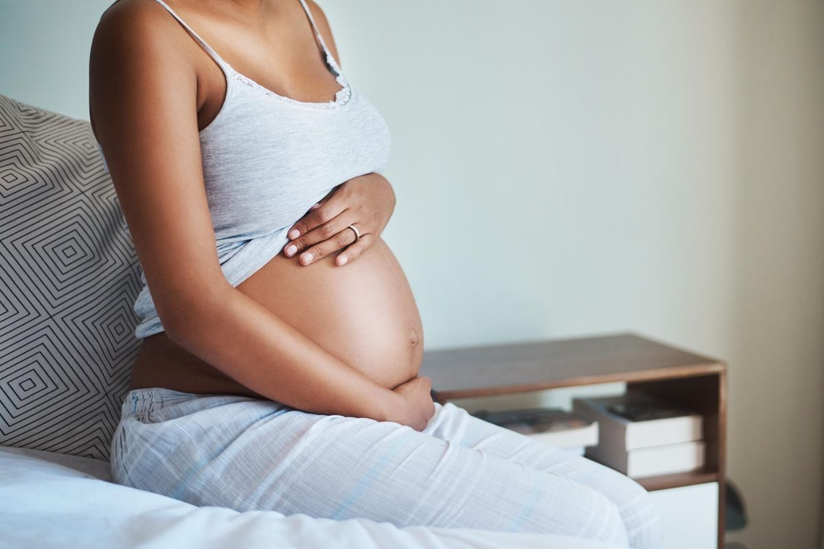 woman holding her pregnant stomach