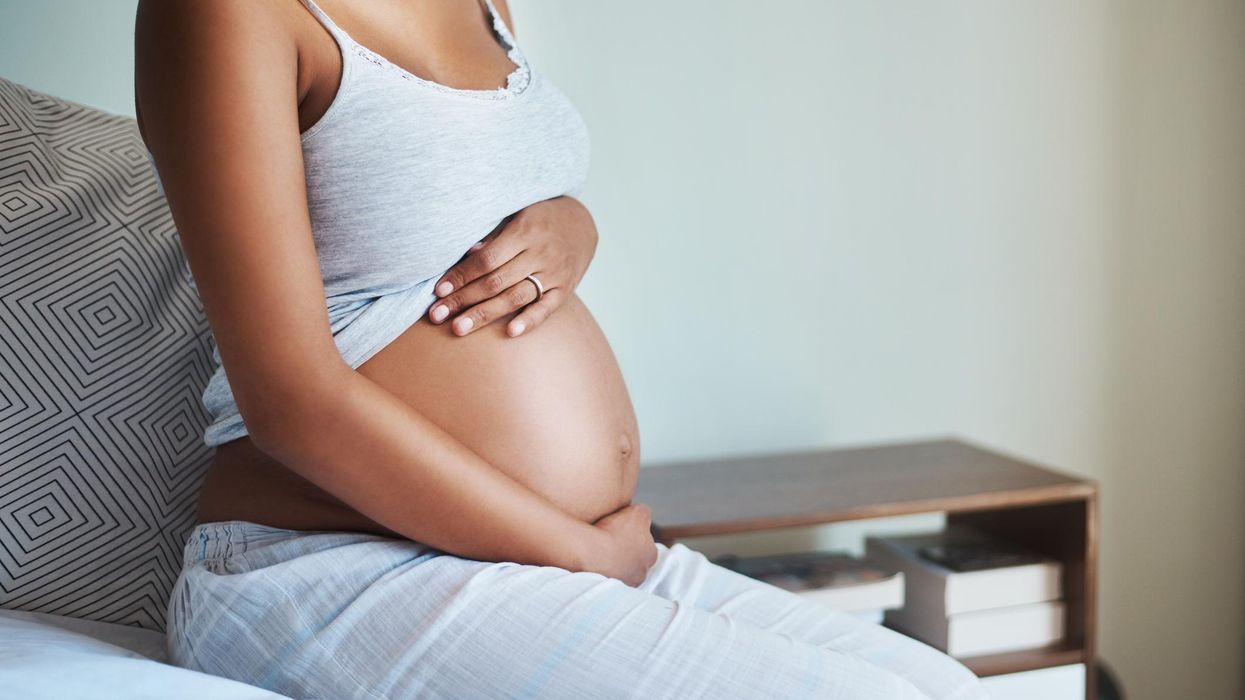woman holding her pregnant stomach