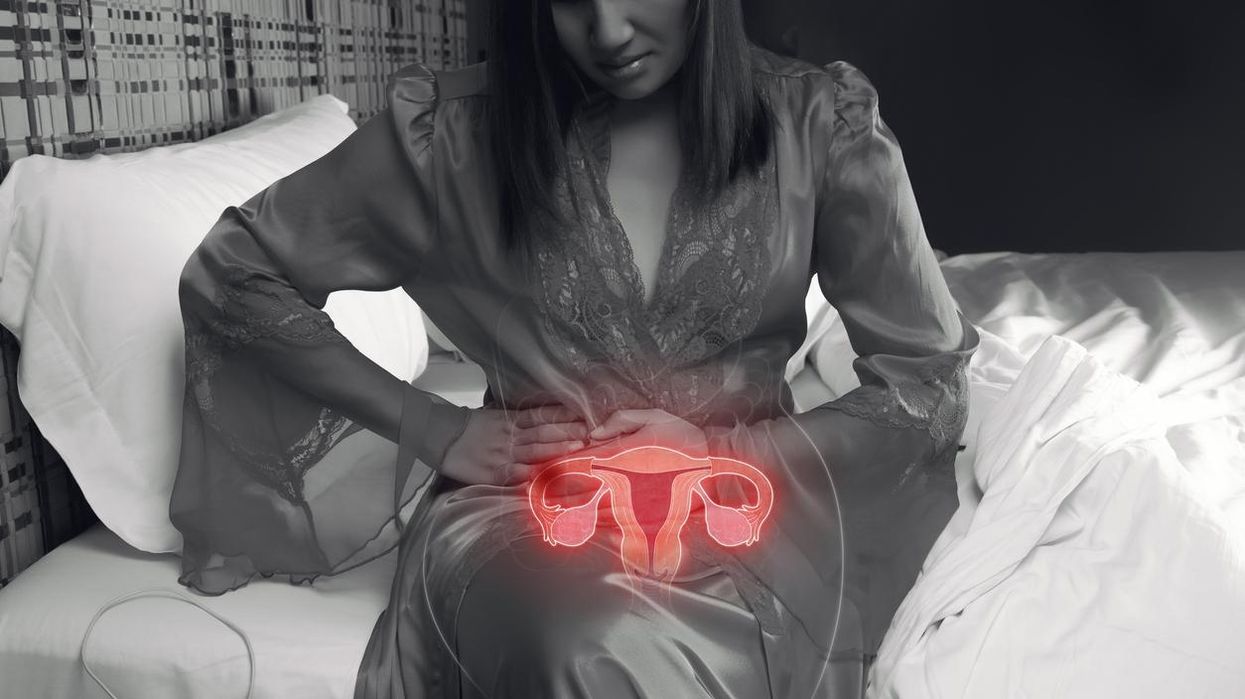 Woman holding her stomach with pelvic pain