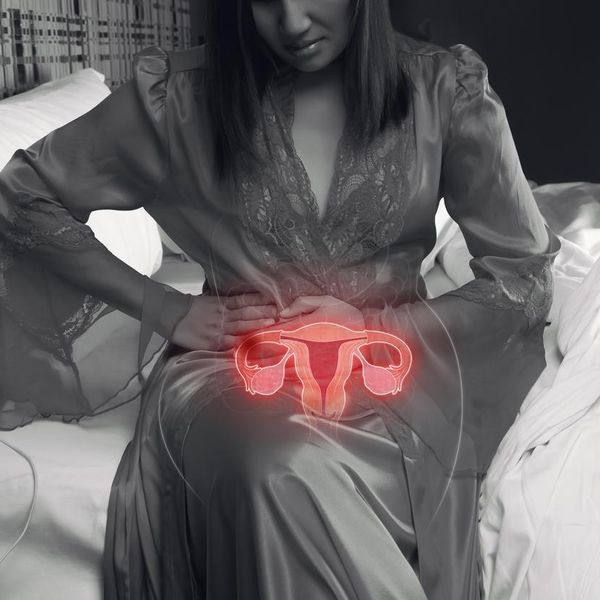 Woman holding her stomach with pelvic pain