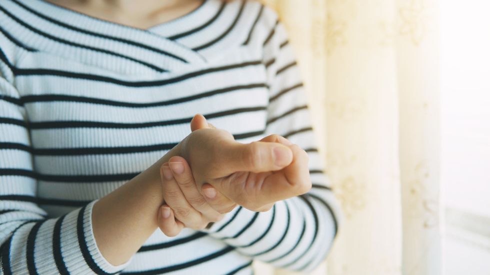 woman holding her wrist in pain