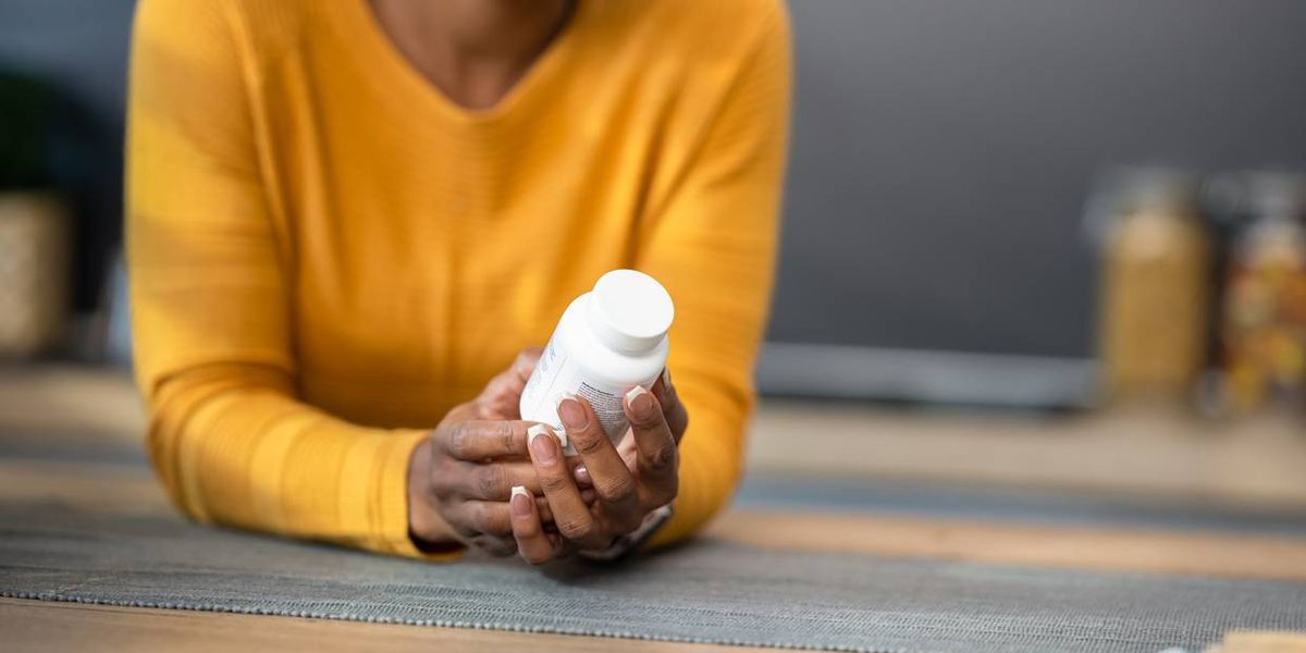 Woman Holding Pill Bottle