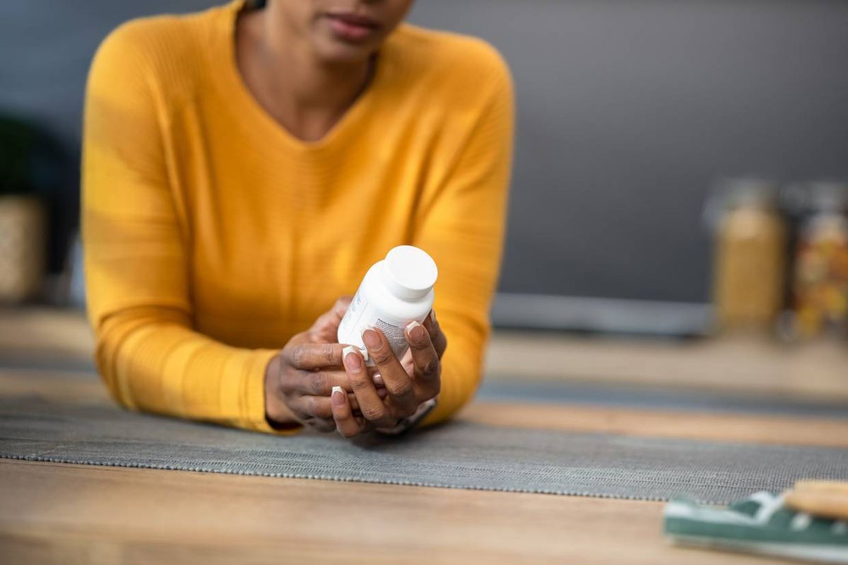 Woman Holding Pill Bottle
