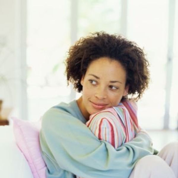 woman hugging a pillow