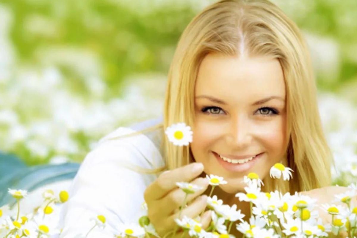 woman in a bed of daisies