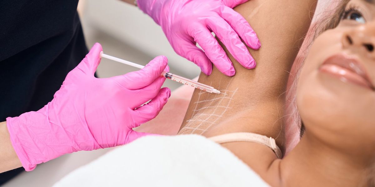 woman in a medical center on a prophylactic injection procedure for the problem of hyperhidrosis