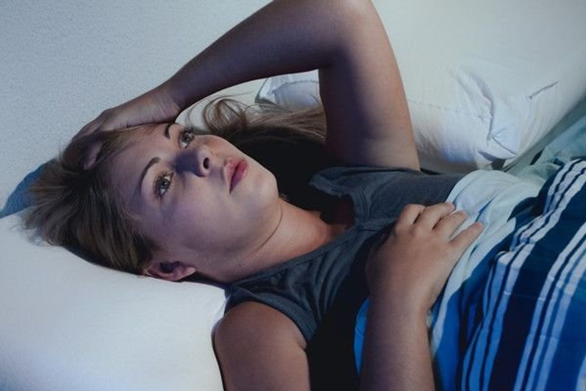 woman in bed suffering from insomnia