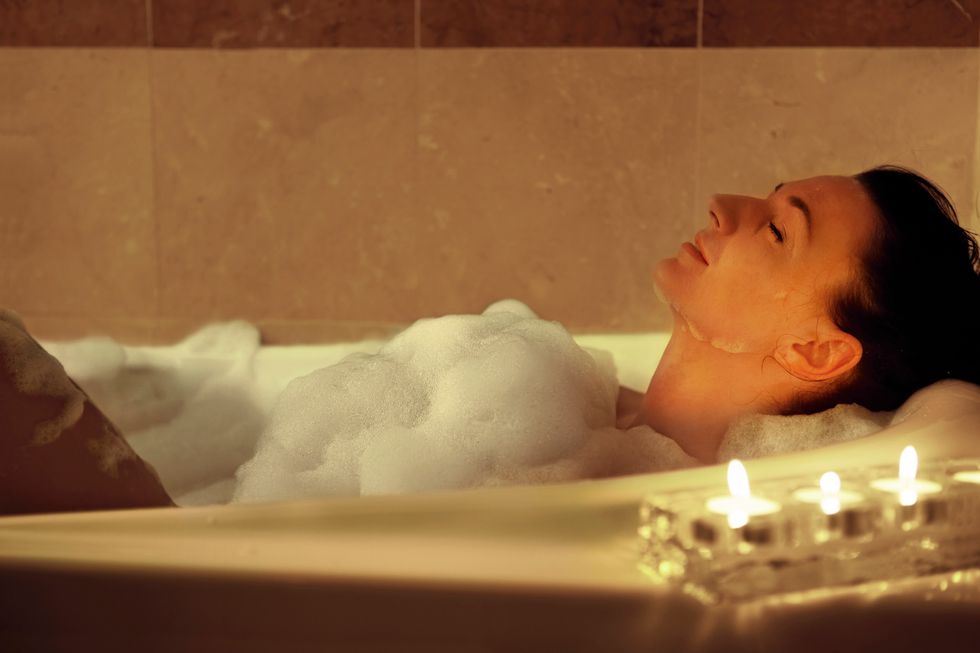 woman in the bath,, candle light.