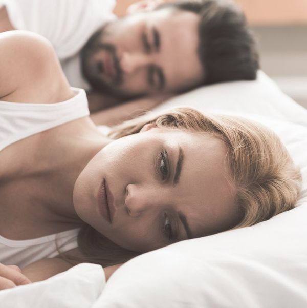 woman laying in bed, worrying about antidepressants affecting her sex drive