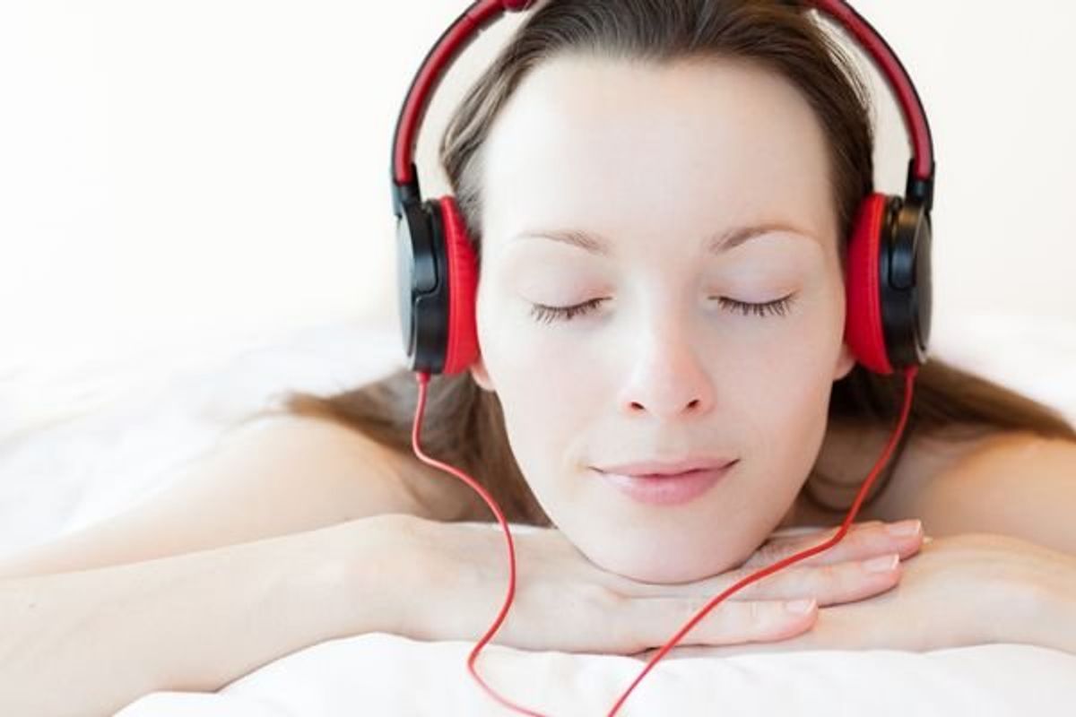 woman listening to music while wearing headphones