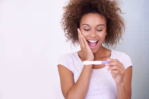 woman looking at a pregnancy test