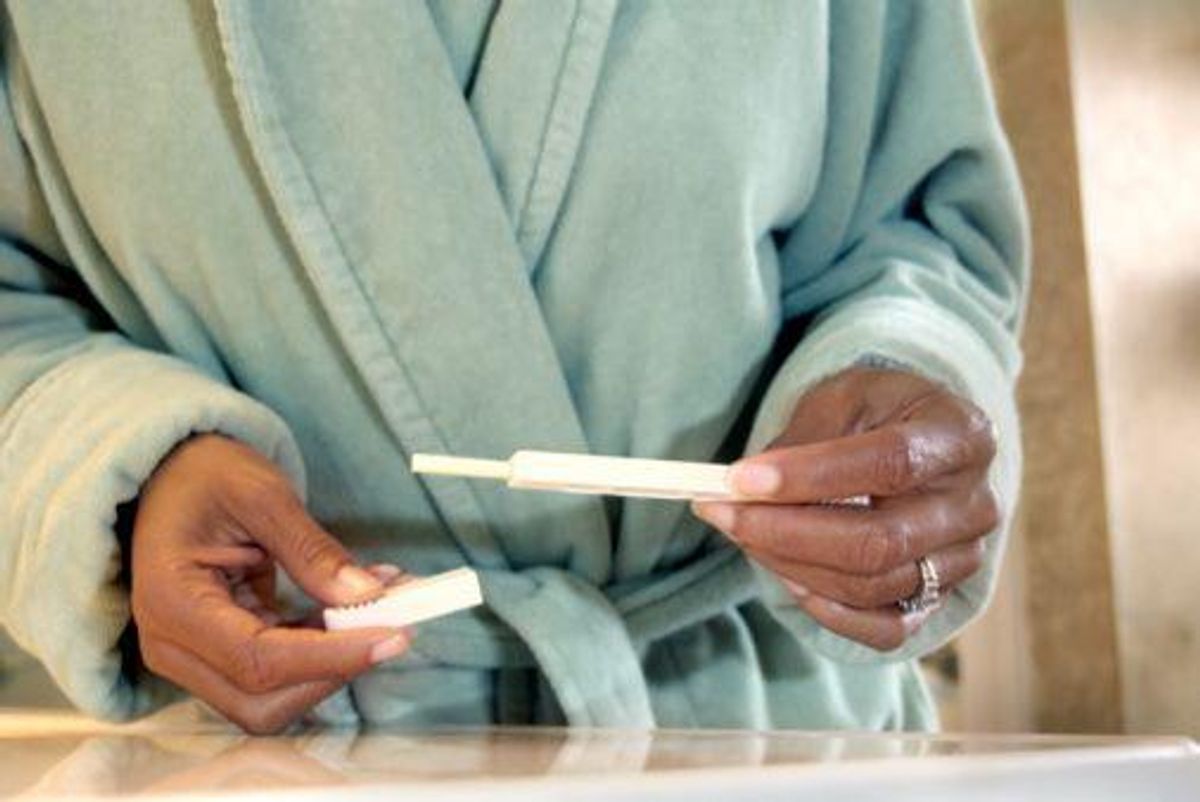 woman looking at a pregnancy test