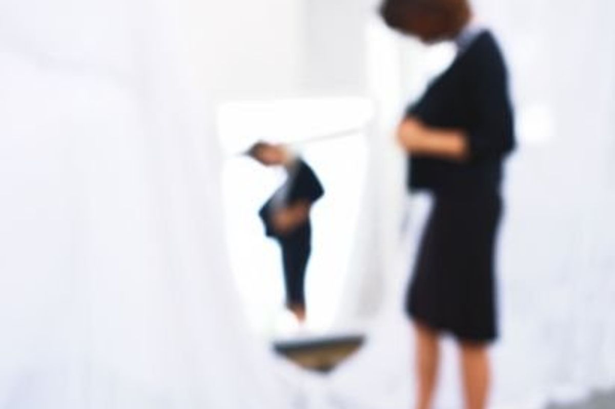 woman looking in a mirror