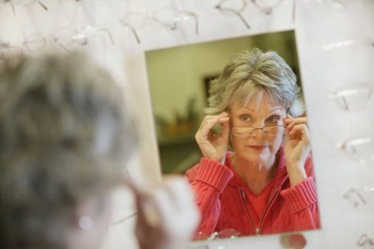 woman looking in the mirror