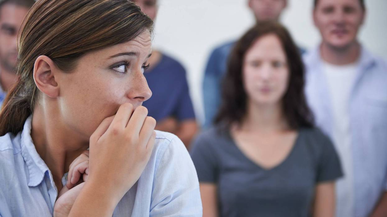 woman looking nervous in front of her coworkers