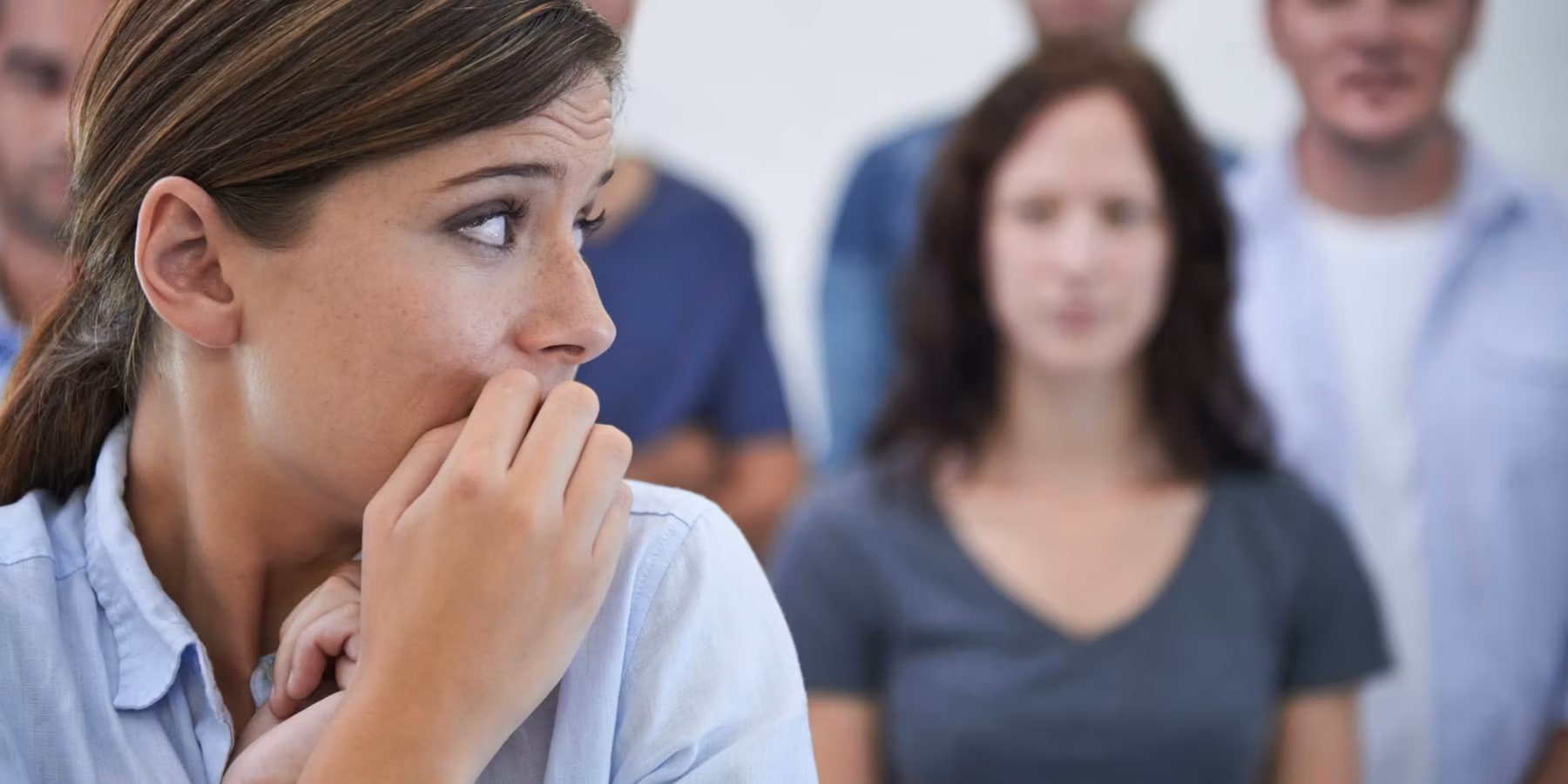 woman looking nervous in front of her coworkers