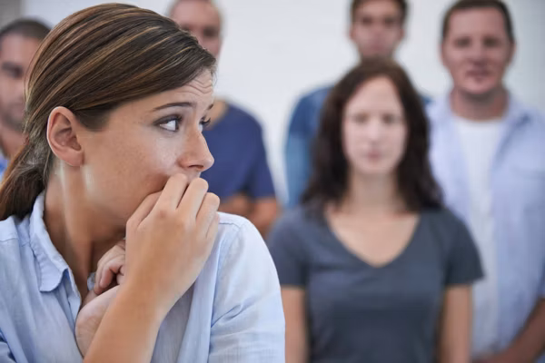 woman looking nervous in front of her coworkers