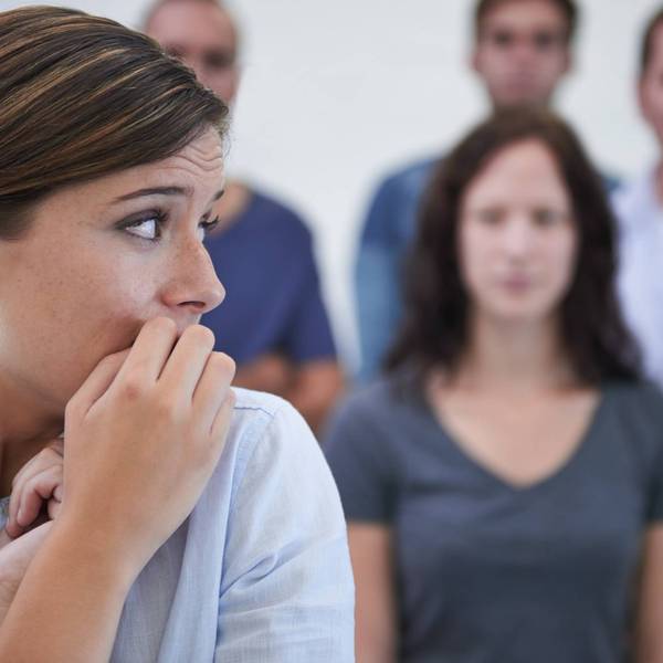 woman looking nervous in front of her coworkers