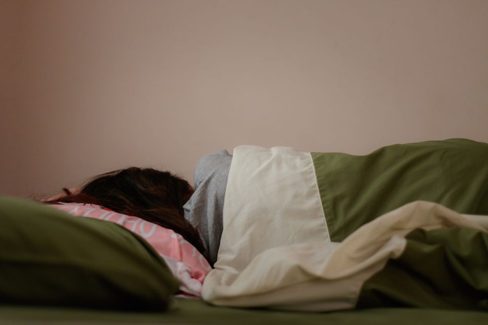 woman lying on her side in bed