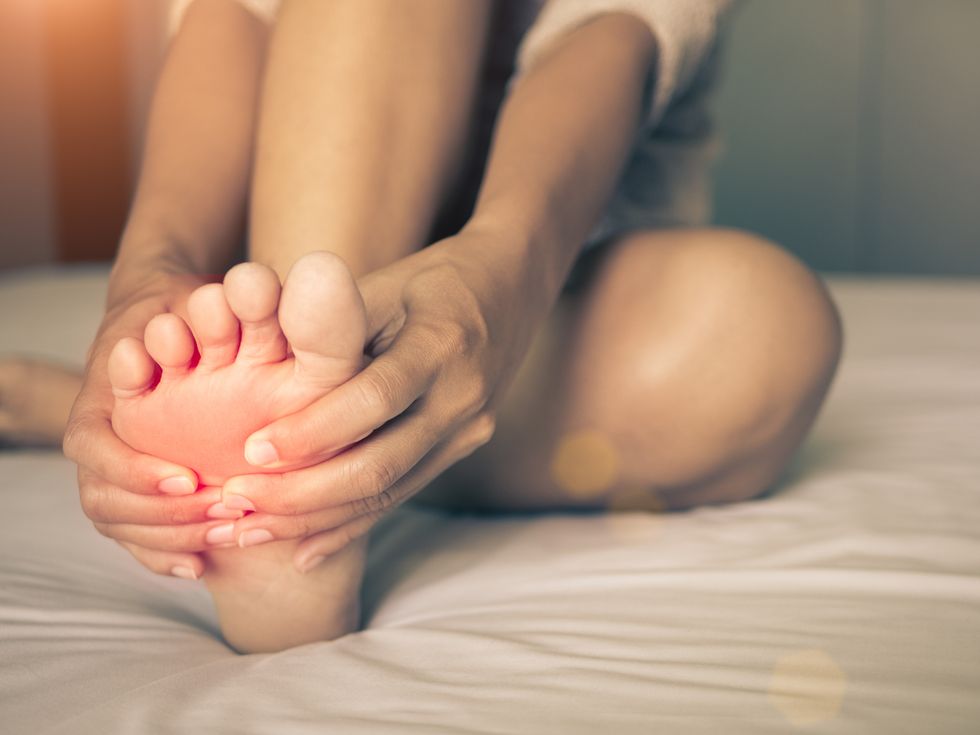 woman massaging her painful foot