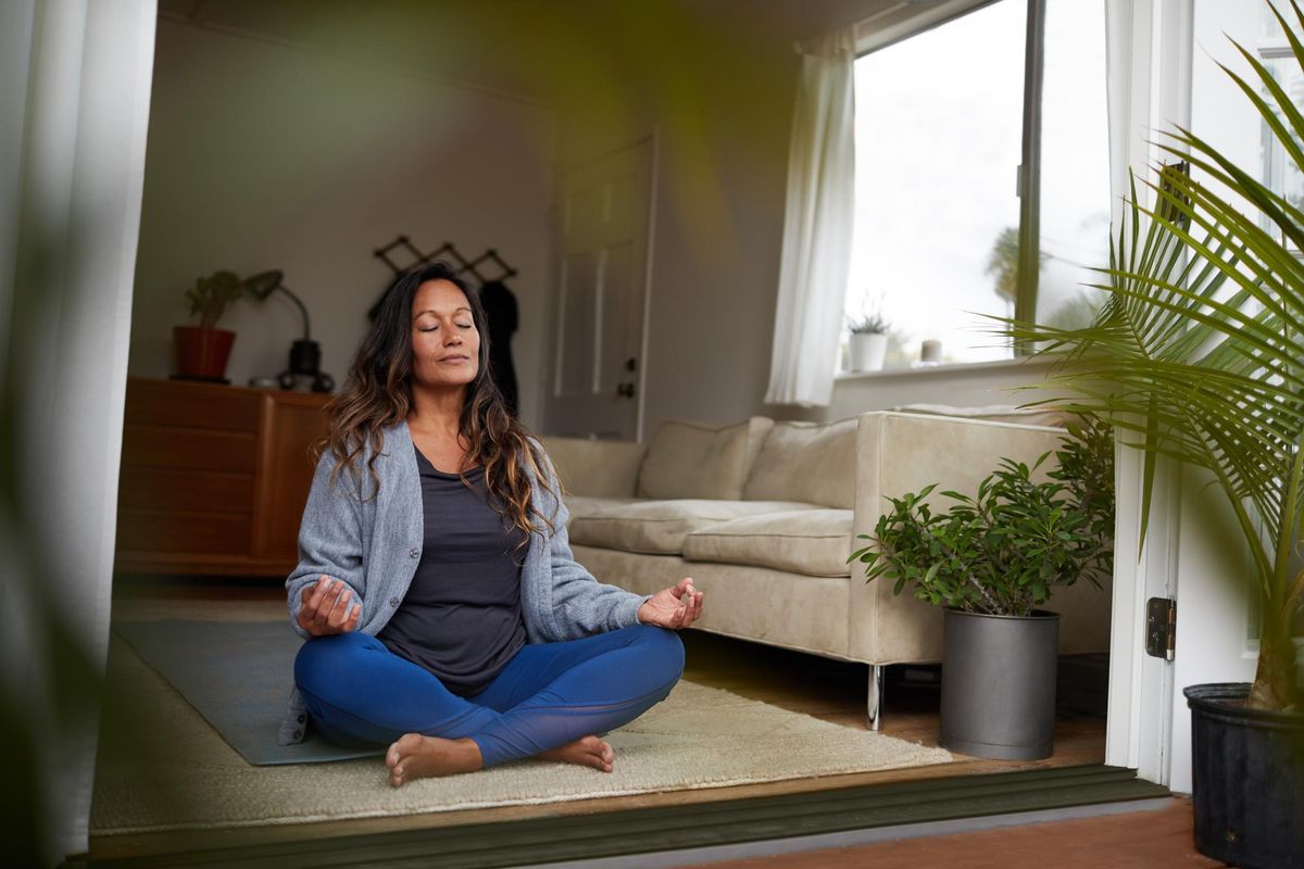 woman meditating while practicing yoga