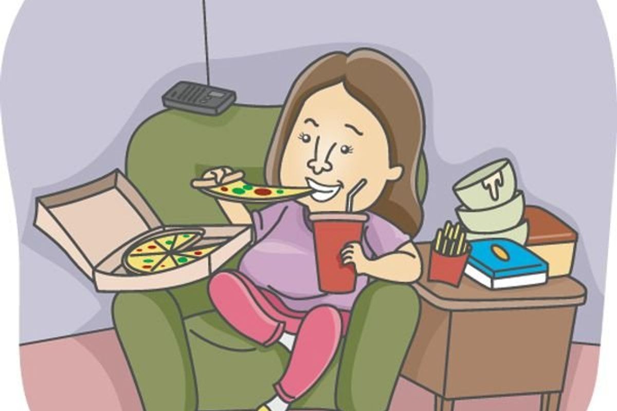 woman on couch eating pizza