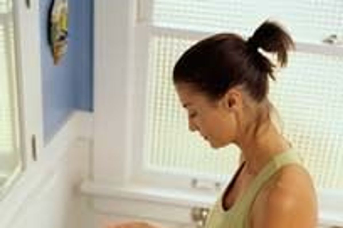 woman opening a jar, in the bathroom