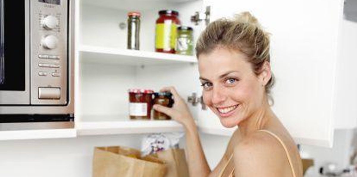 woman putting groceries away