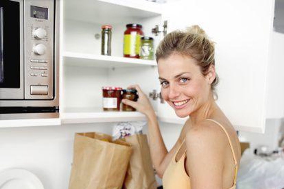 woman putting groceries away