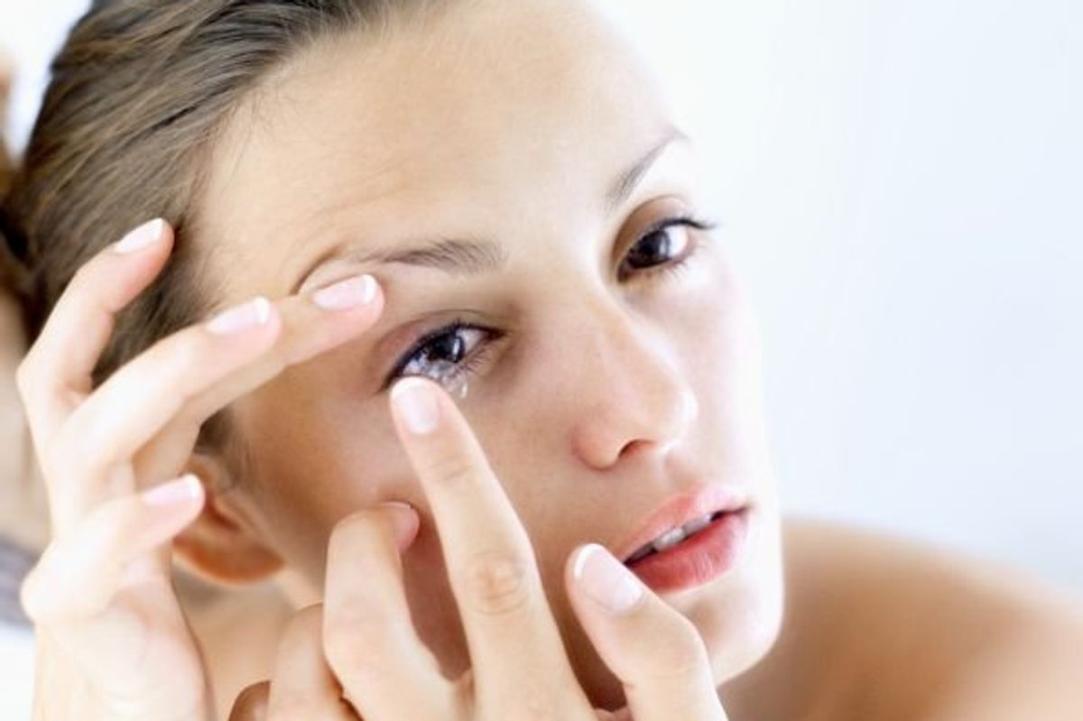 woman putting in contact lenses
