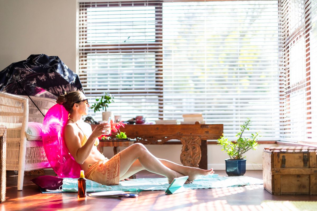 Woman relaxes as if on a summer holiday during COVID-19 travel ban