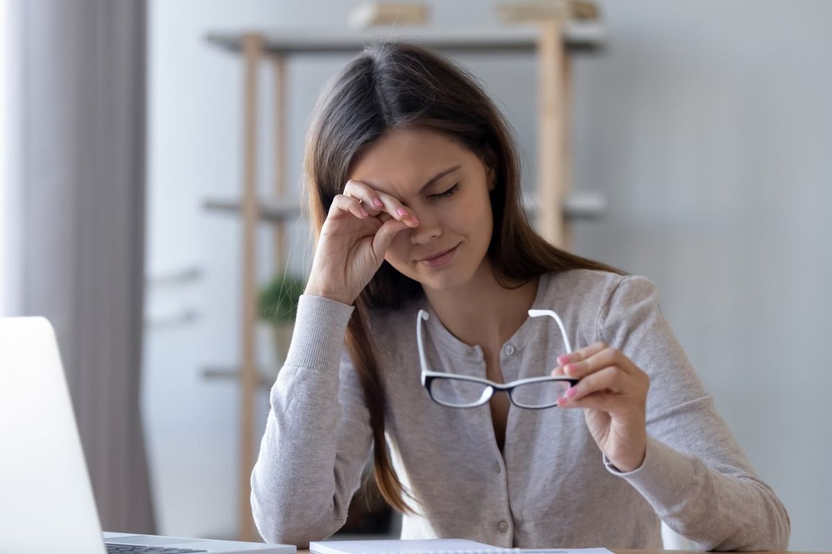 woman rubbing eyes suffering from dry eye