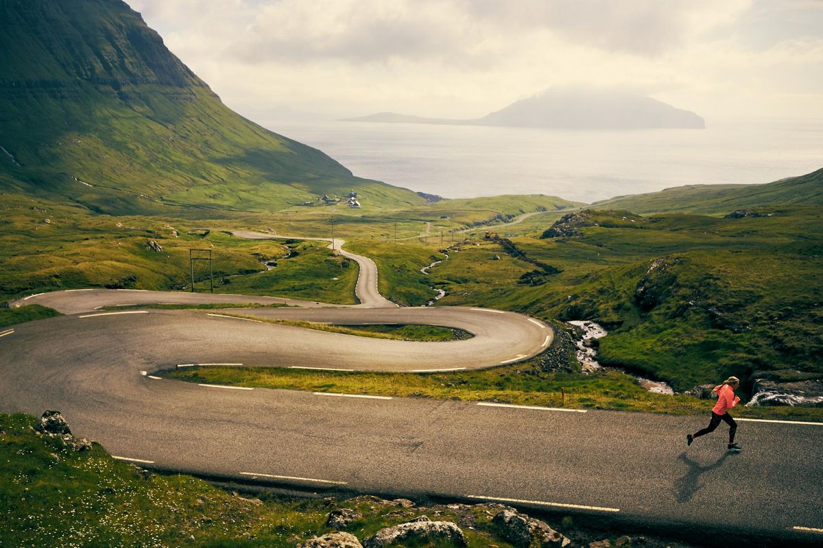 woman running on a winding road