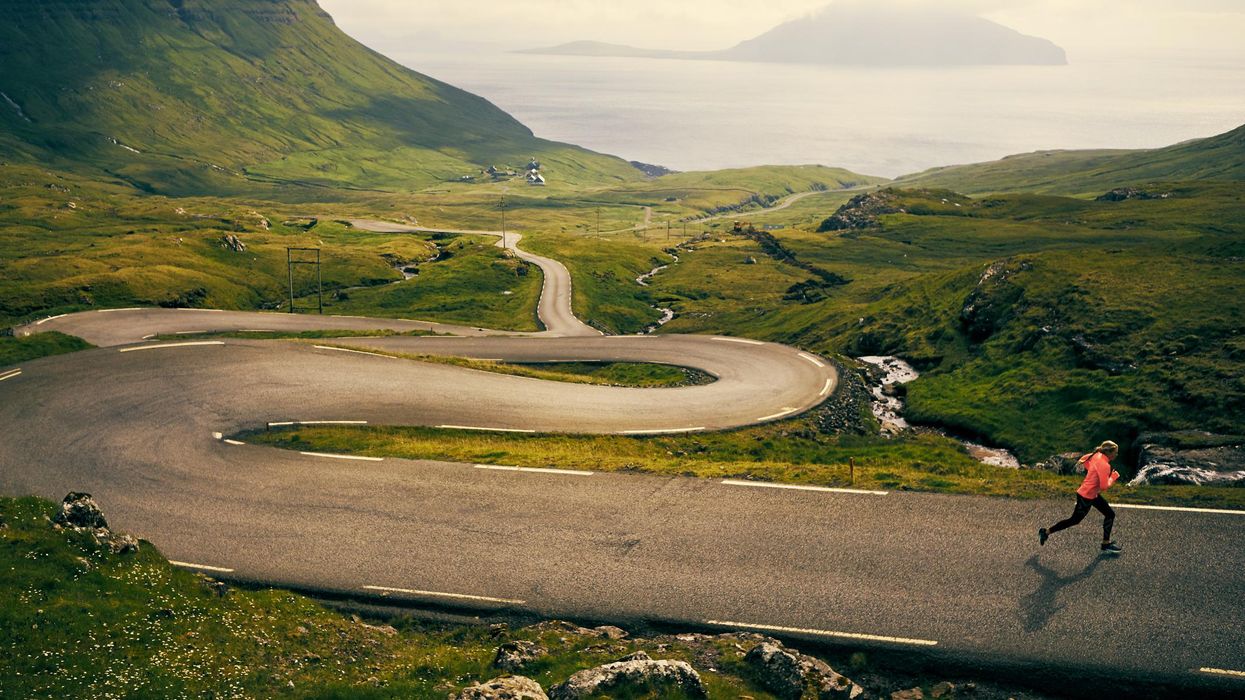 woman running on a winding road