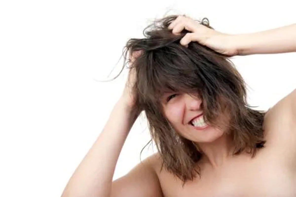 woman scratching her scalp