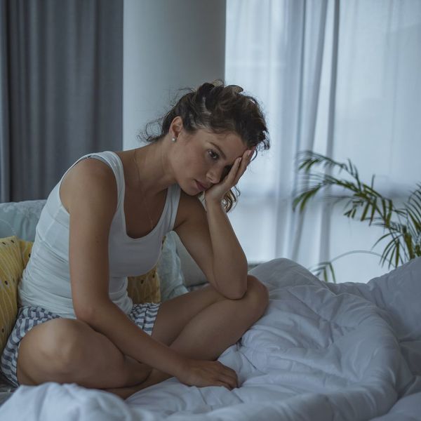 woman sitting home alone, worried
