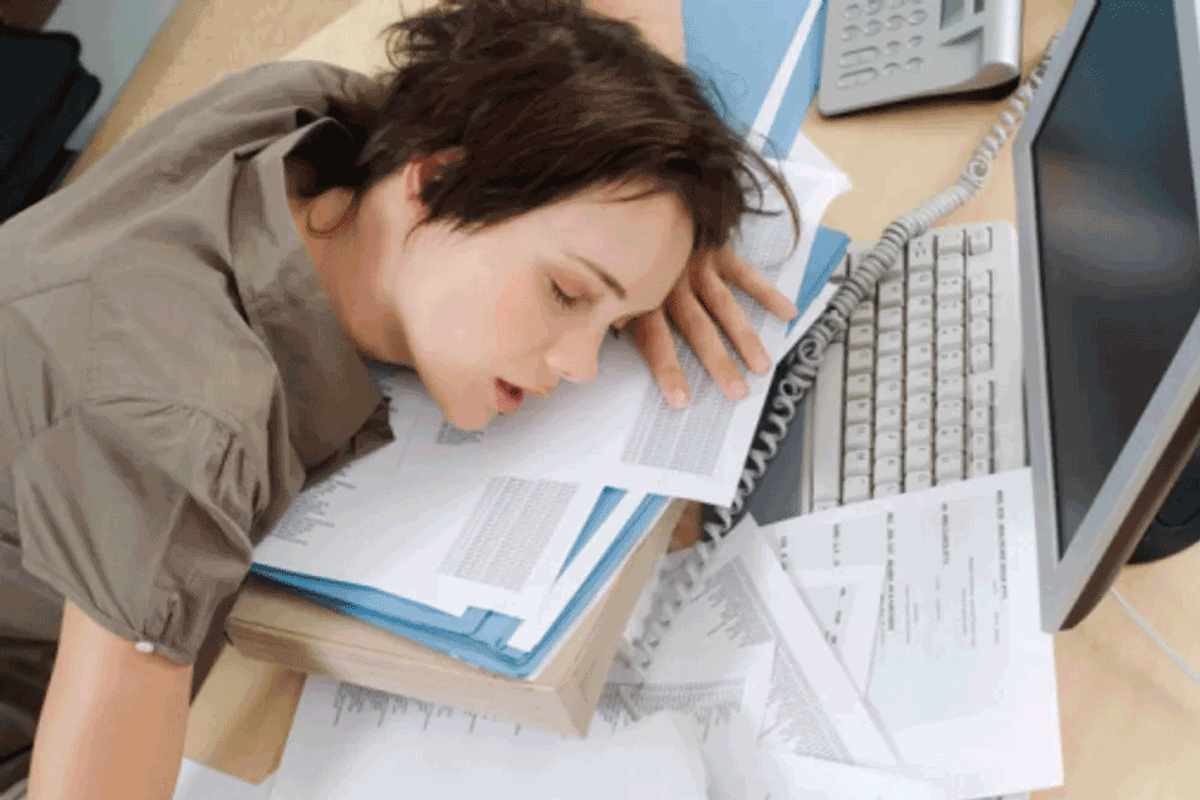 woman sleeping on files at work
