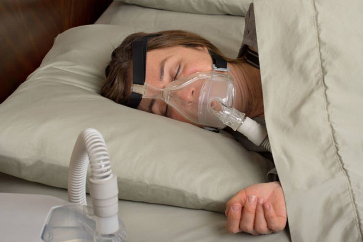 woman sleeping with sleep apnea mask
