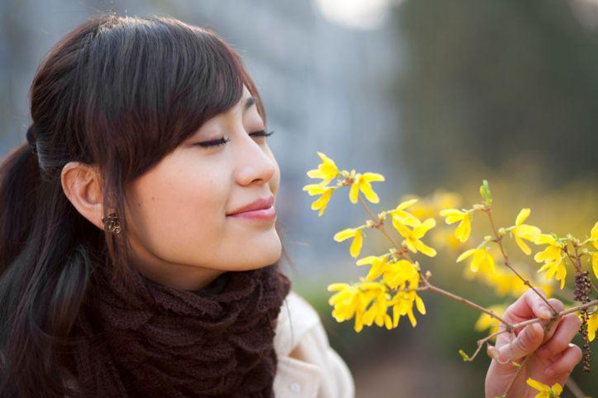 woman smelling flowers