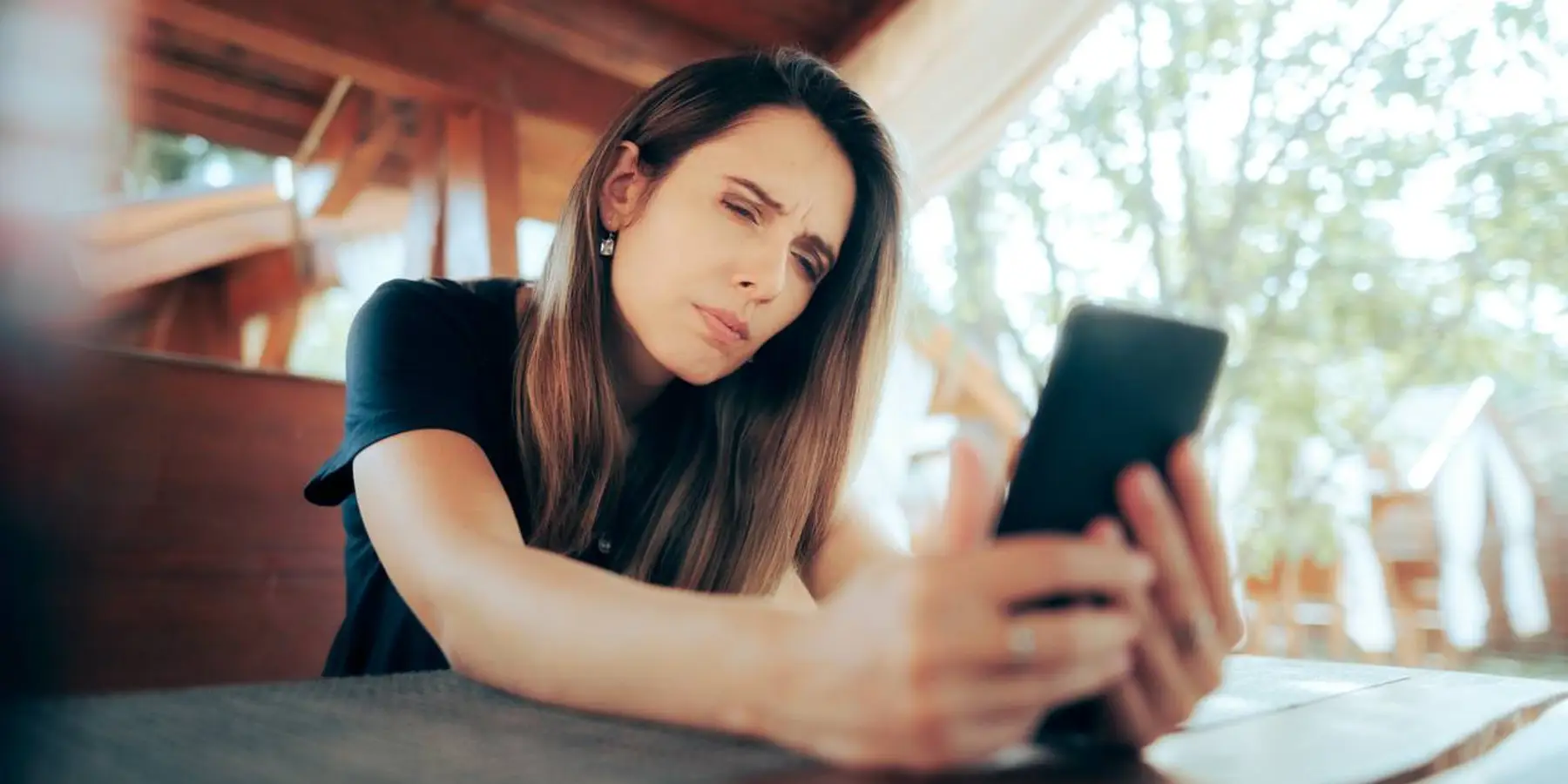 Woman Squinting Trying to Read Small Text on her Phone