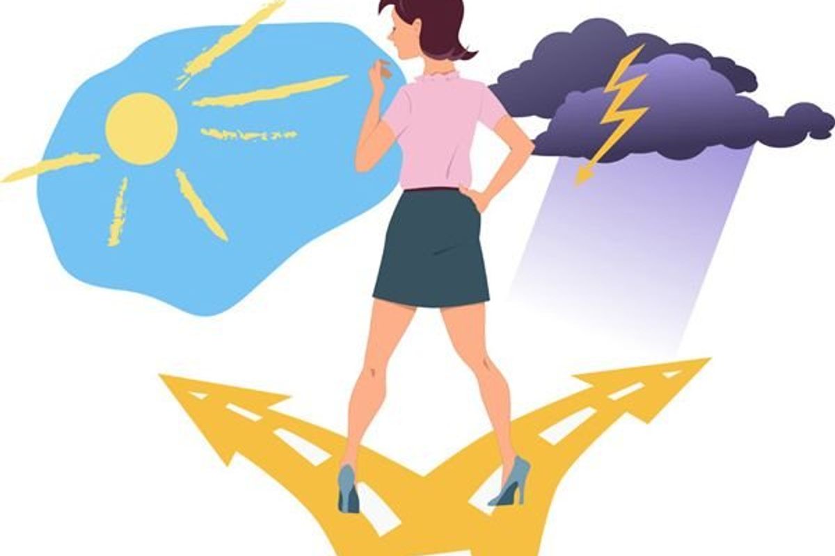 woman standing in a fork in the road