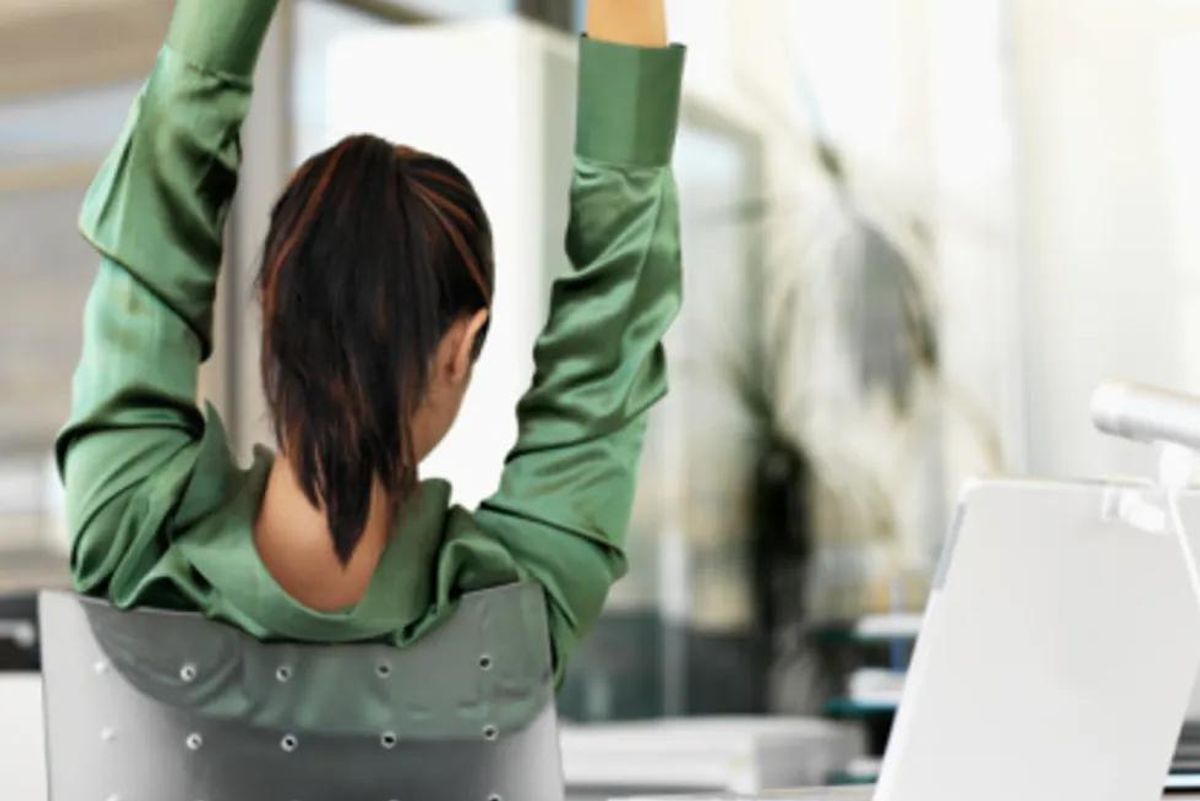 woman stretching at her desk